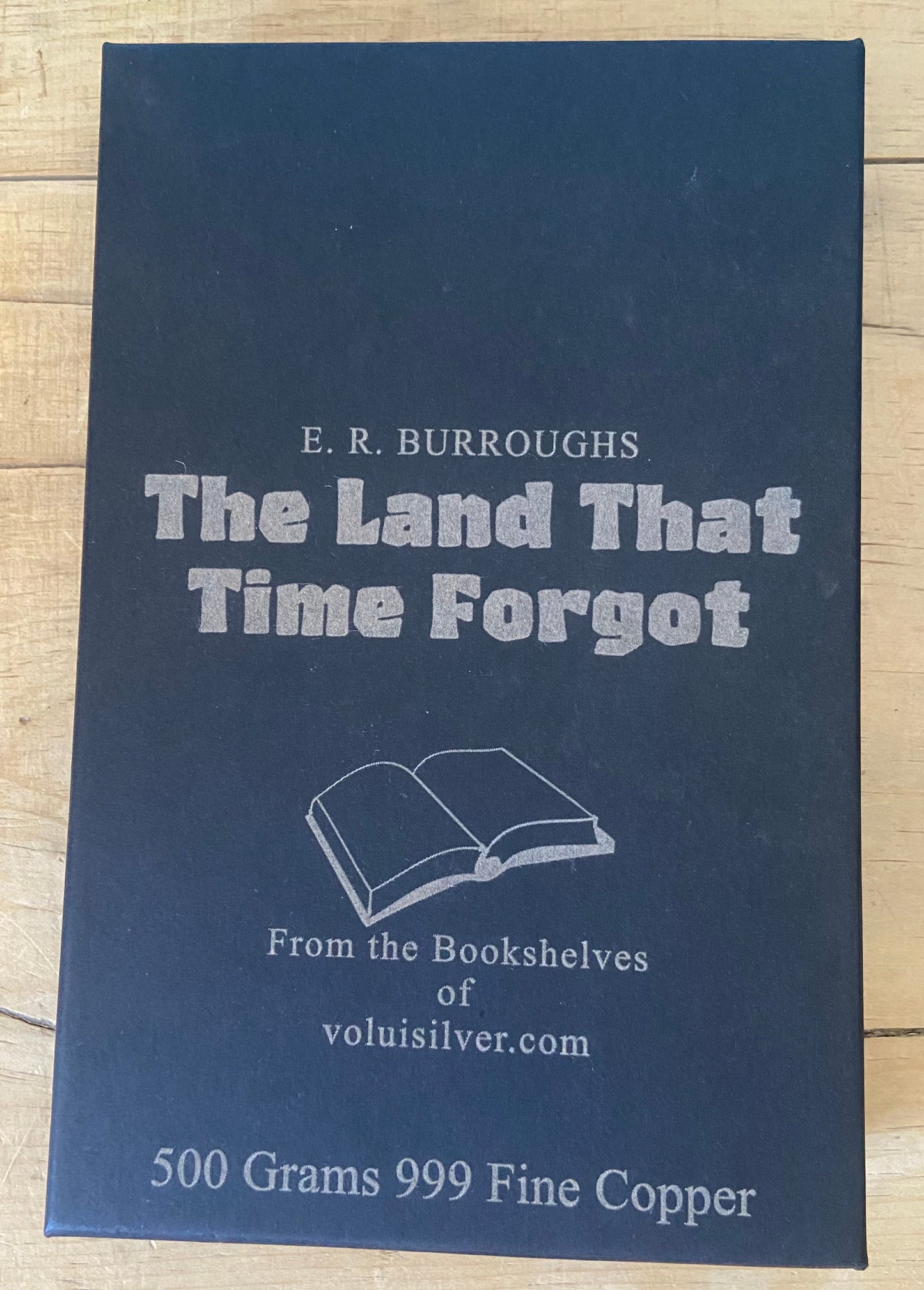 A dark blue book titled 'The Land That Time Forgot' by E. R.