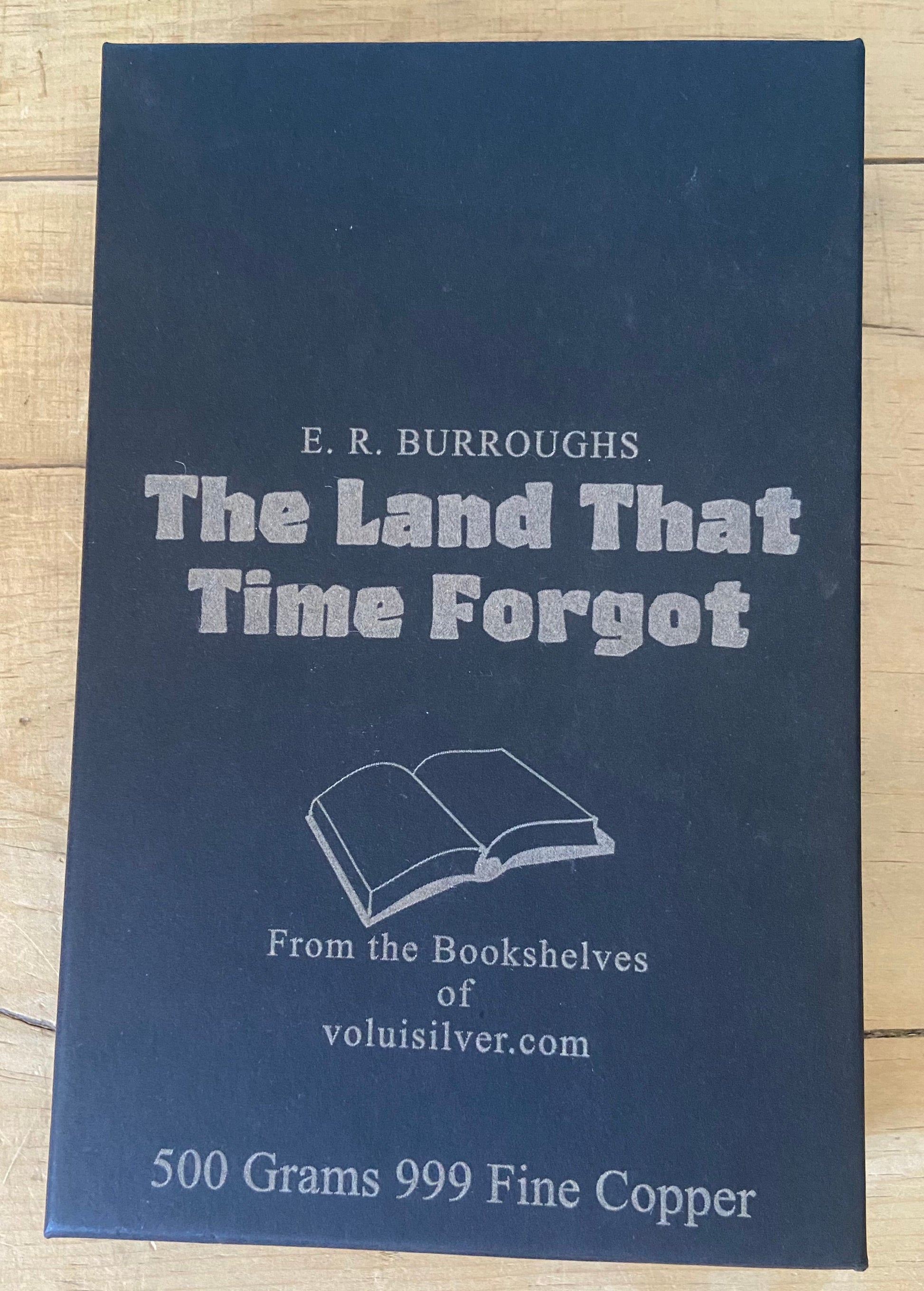 A dark blue book titled 'The Land That Time Forgot' by E. R.