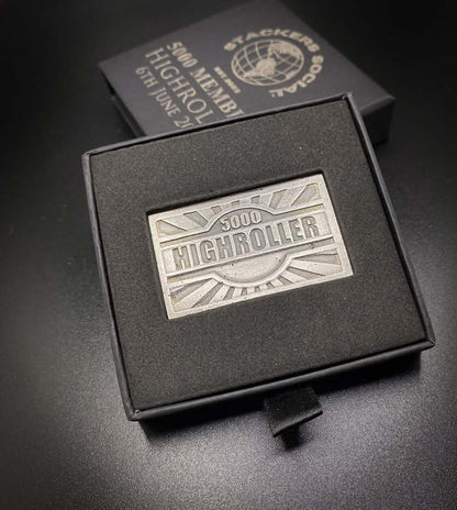 A  999 fine silver Stackers Social 5K and a Union Jack motif, displayed in a black presentation box. A second black box is visible behind it on a dark surface.